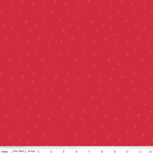Red fabric with small lighter red pine tree scattered about