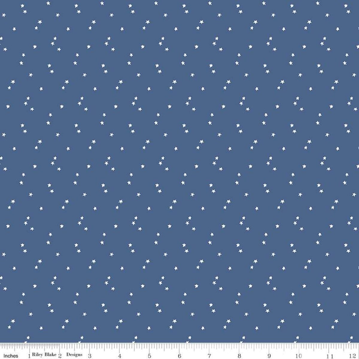 Blue fabric with small white star pattern and a ruler at the bottom for scale.