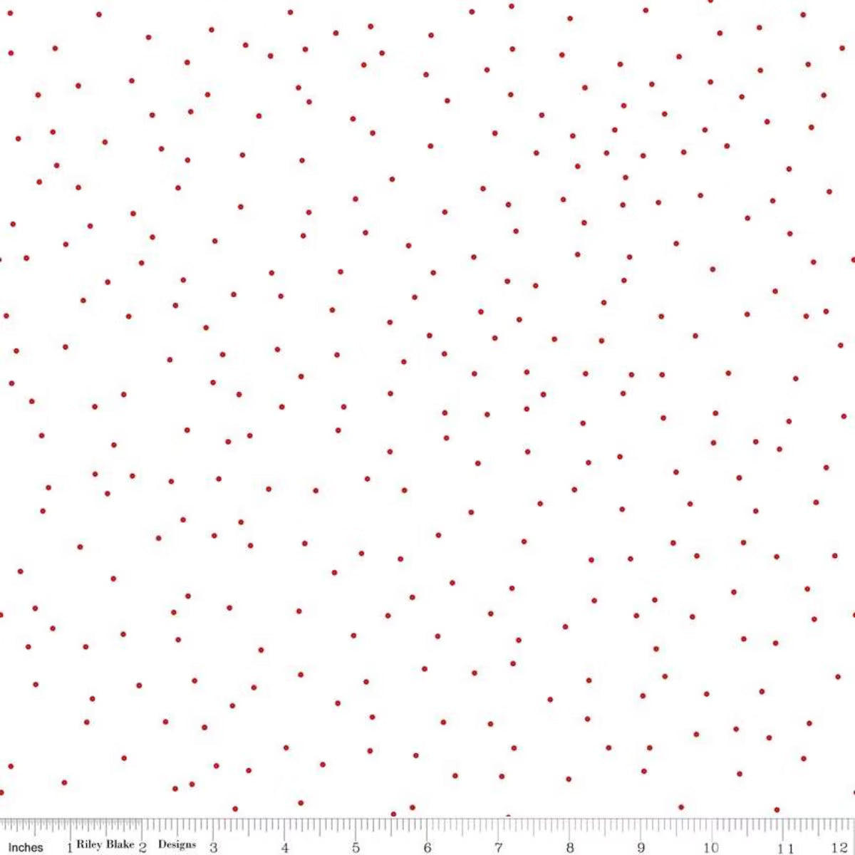 A white fabric or material swatch with a scattered pattern of small dark red dots, shown flat with a ruler along the bottom edge for scale.