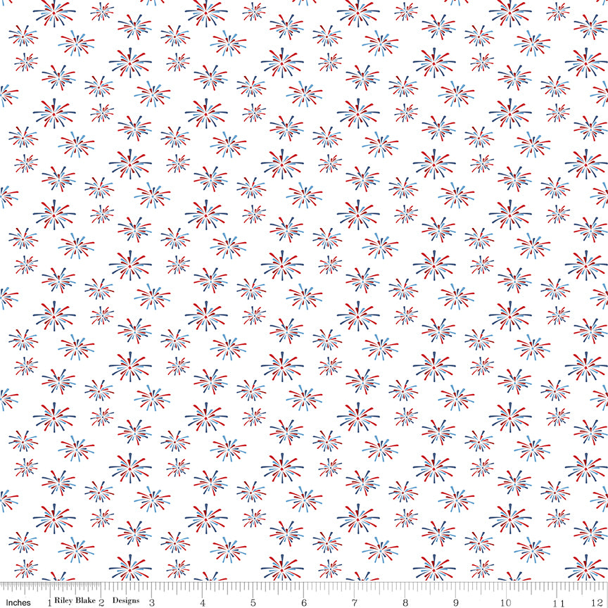 Patterned fabric with fireworks design on a white background, featuring red and blue colors.