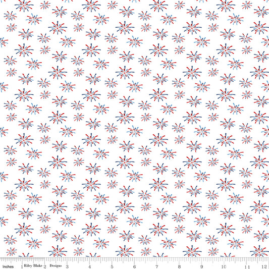Patterned fabric with fireworks design on a white background, featuring red and blue colors.