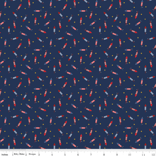Pattern of small red and white striped rockets on a blue background with a ruler at the bottom.