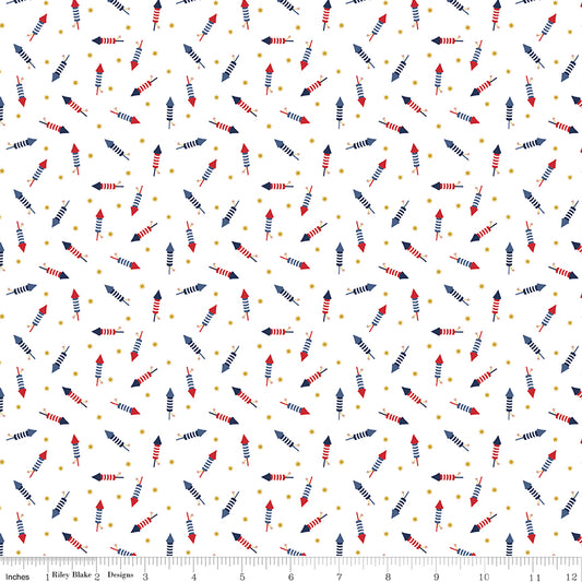 Patterned fabric with small arrows and dots on a white background, featuring a ruler for scale.