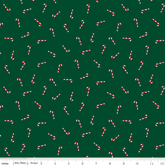 Pattern of candy canes on a green background with a ruler at the bottom.