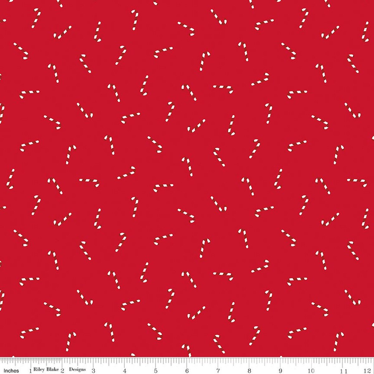 Red fabric with a repeating pattern of small white candy cane motifs and a 12-inch ruler along the bottom edge.