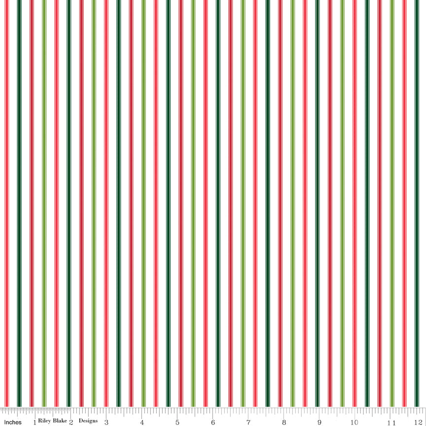 A repeating vertical stripe pattern on a white background with alternating dark green, red, and light green stripes. A small ruler scale and the text 'Riley Blake Designs' are visible along the bottom edge.