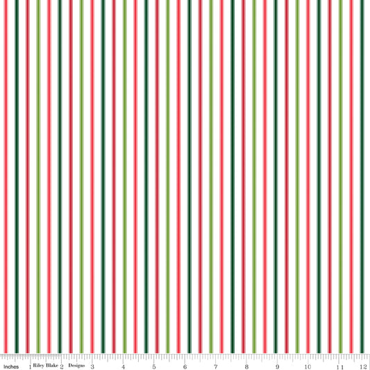 A repeating vertical stripe pattern on a white background with alternating dark green, red, and light green stripes. A small ruler scale and the text 'Riley Blake Designs' are visible along the bottom edge.