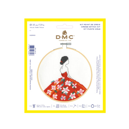 Cross-stitch kit packaging with a woman in a floral dress design on a white background