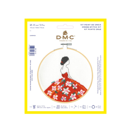 Cross-stitch kit packaging with a woman in a floral dress design on a white background