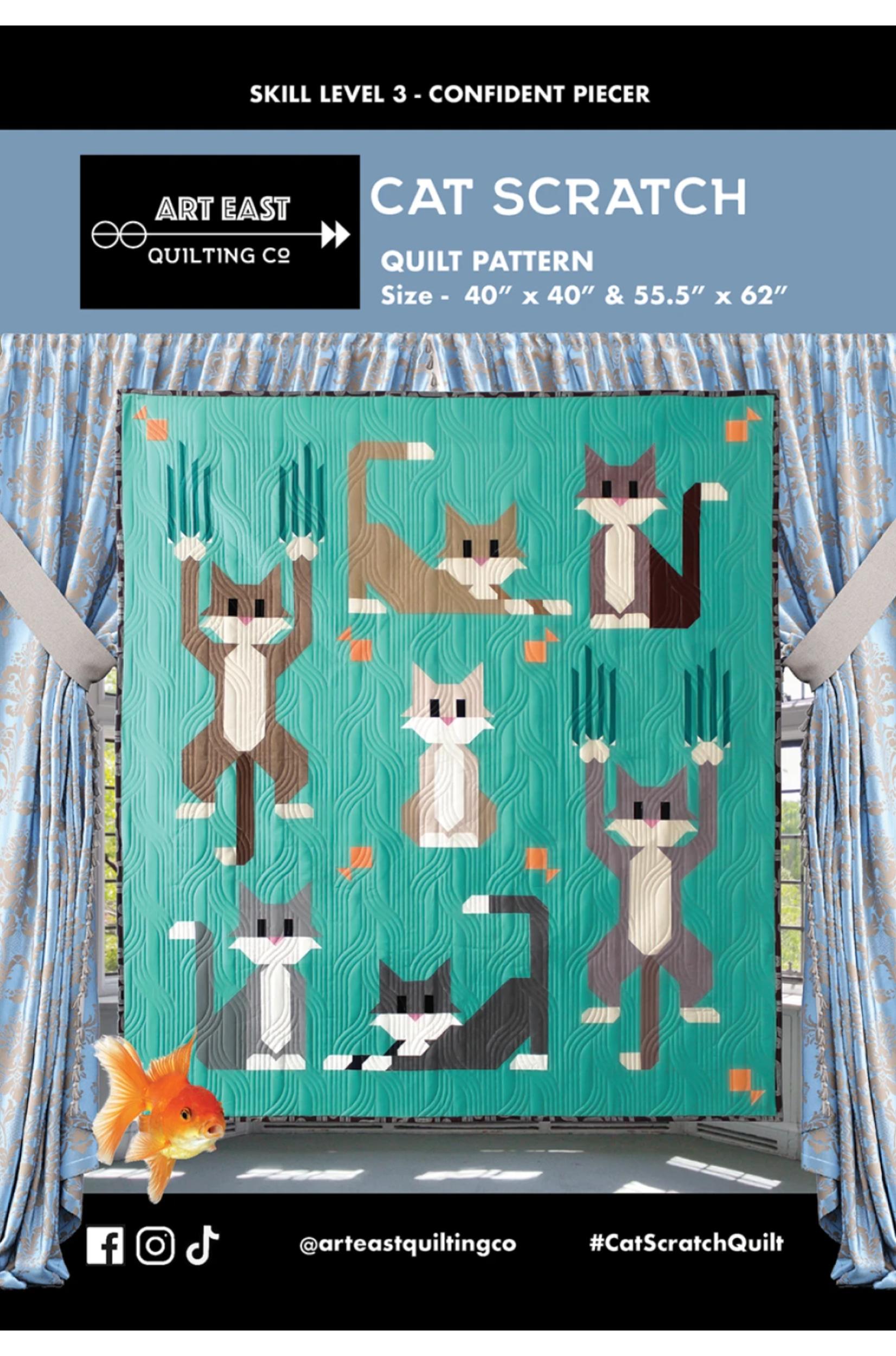 Cat Scratch quilt pattern with cartoon cats on a teal background, displayed against a fabric background.