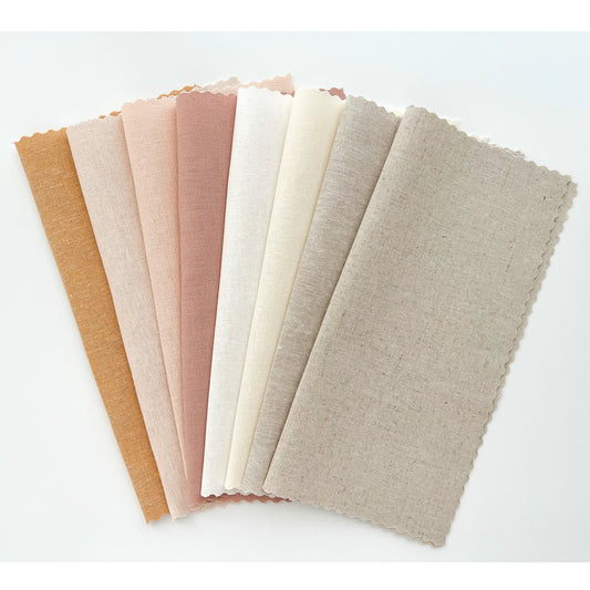An array of linen embroidary fabrics in warm colors