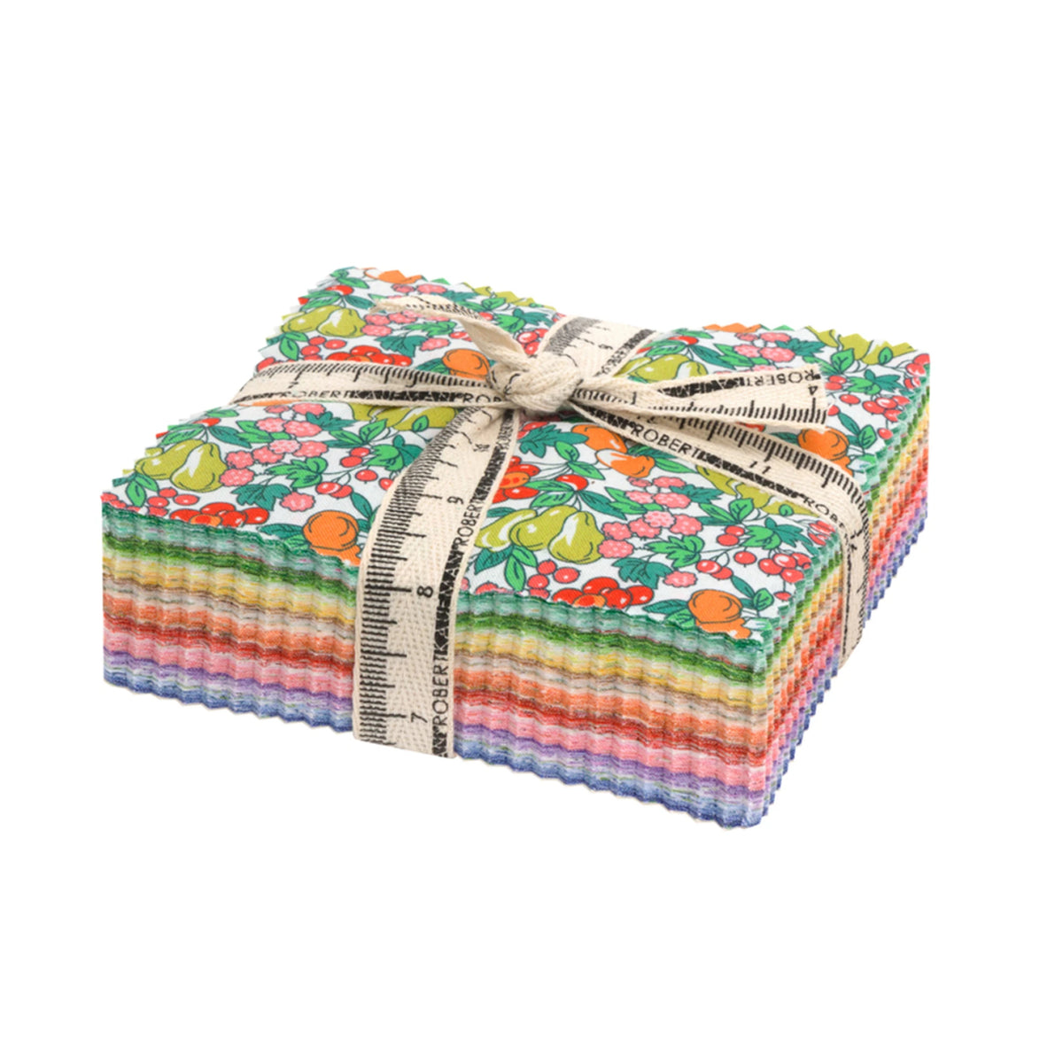 A stack of colorful patterned fabric squares tied with a cream ribbon printed with a measuring tape design, on a plain white background.