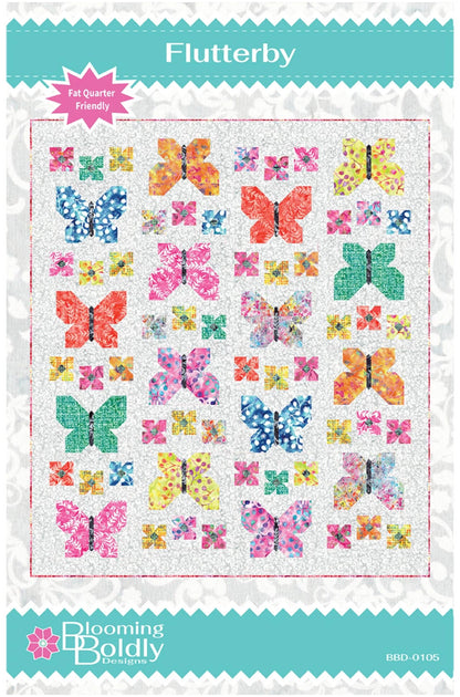 A quilt pattern cover for 'Flutterby' by Blooming Boldly Designs, featuring a grid of colorful butterfly and floral patchwork designs on a white background with teal borders.