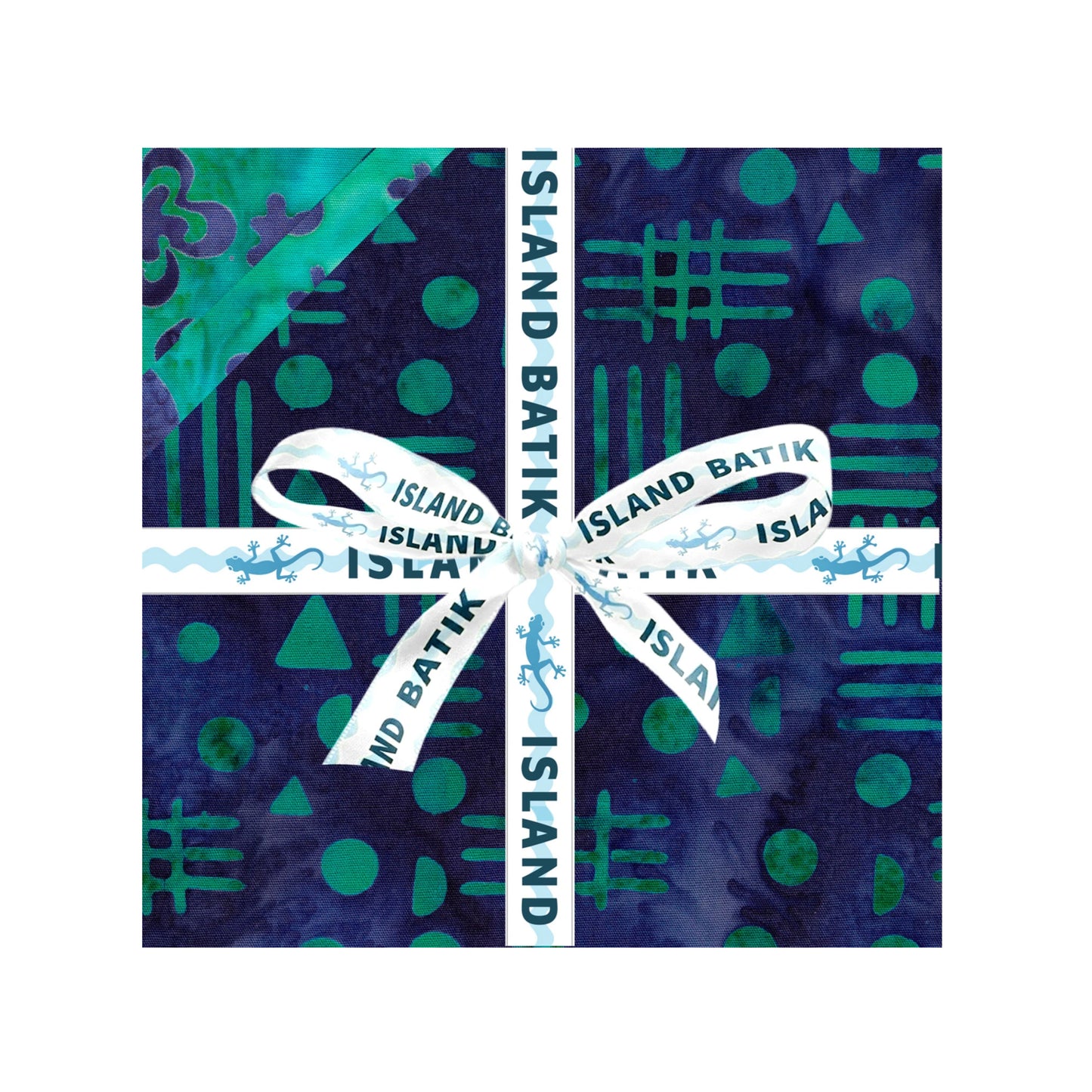 A square fabric sample or swatch with a batik-style pattern in deep navy and teal, wrapped with a white ribbon printed with 'ISLAND BATIK' and tied in a bow at the center, shown on a plain white background.