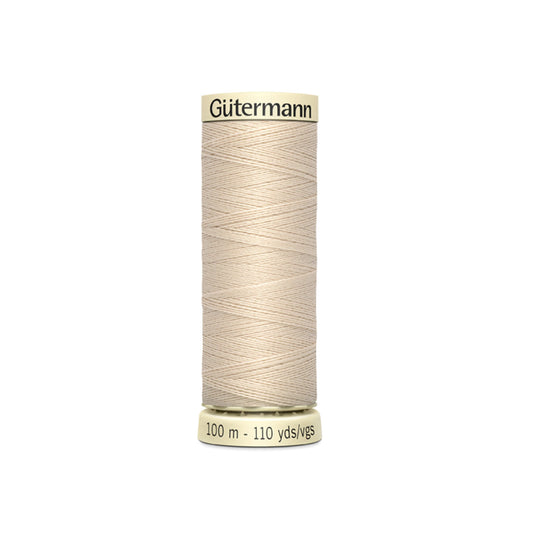 Spool of Gutermann thread on a white background