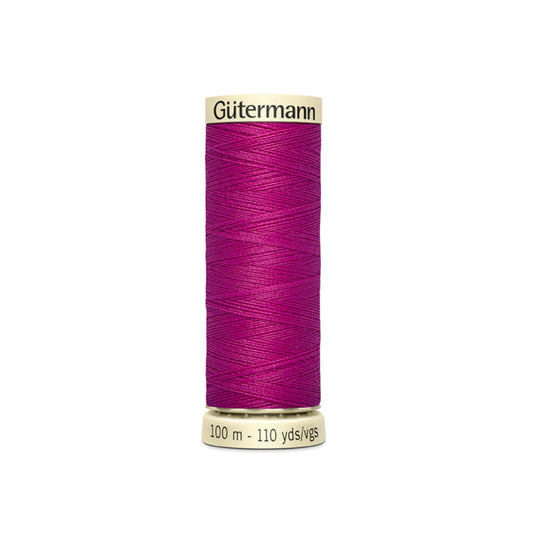 Spool of Gutermann thread on a white background