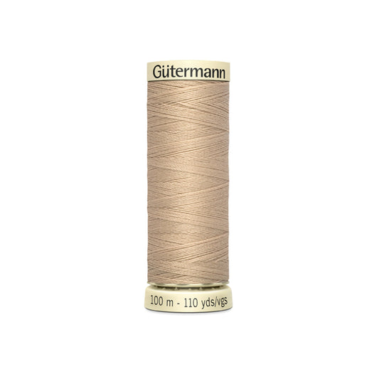 Spool of Gutermann thread on a white background