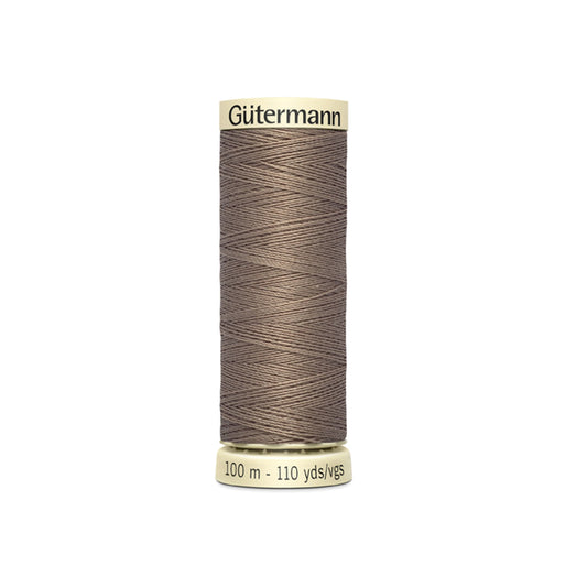 Spool of Gutermann thread on a white background