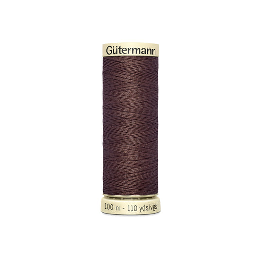 Spool of Gutermann thread on a white background