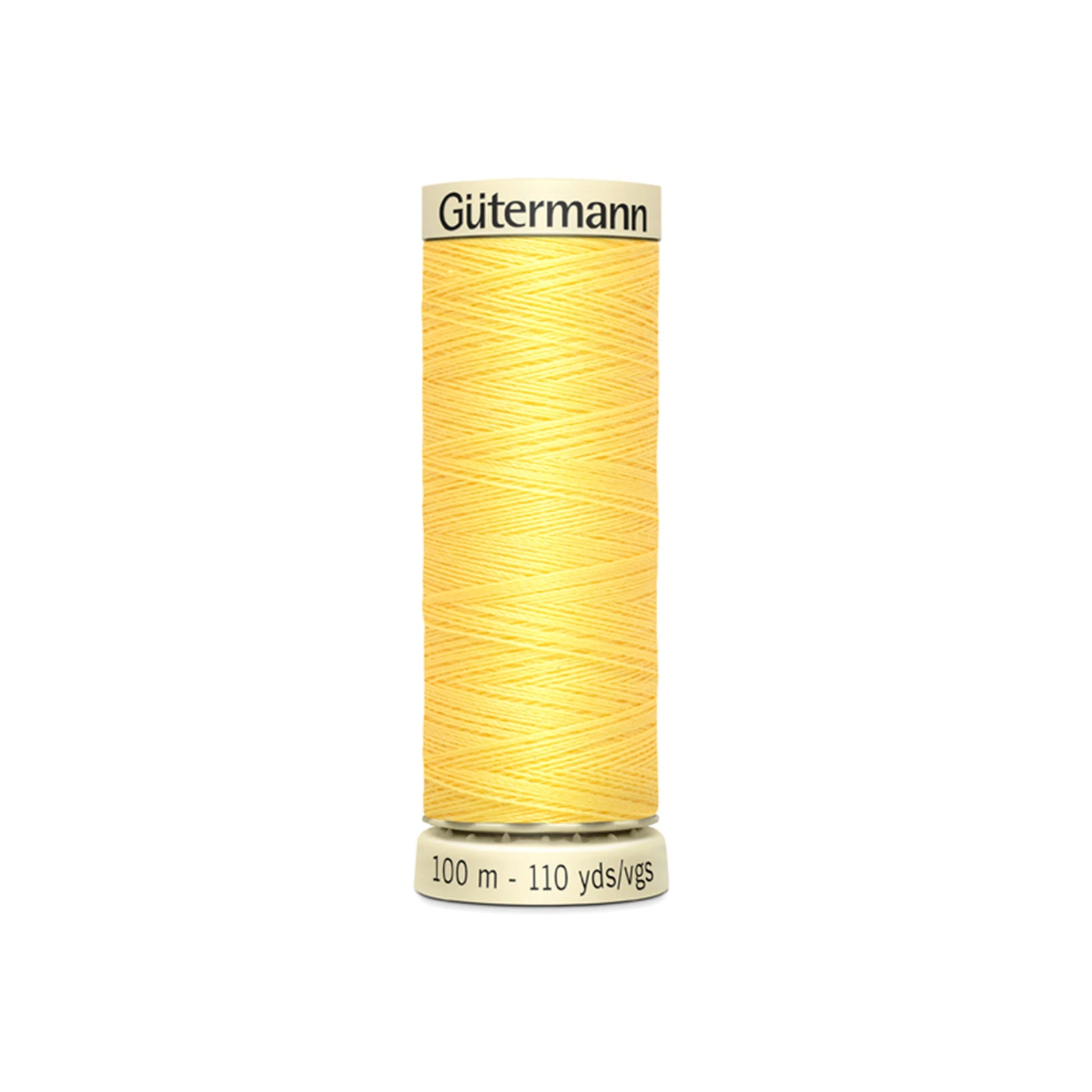Spool of yellow Gutermann thread on a white background