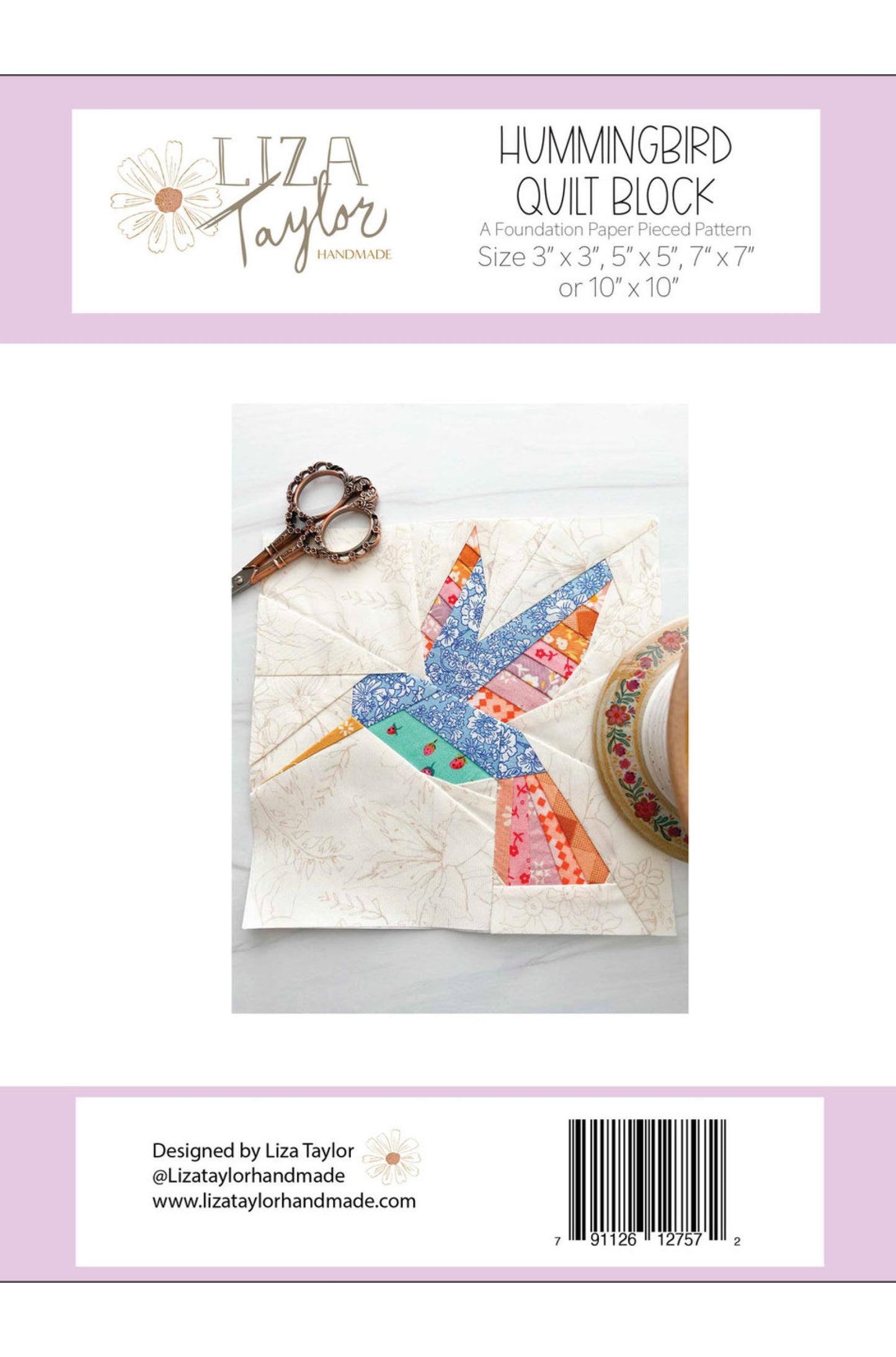 Back cover of a quilting pattern package for the Hummingbird Quilt Block by Liza Taylor, showing a fabric hummingbird patch on a quilted square, with scissors and fabric roll nearby. The package has a white and pale lavender design with product title, sizes, and a barcode.