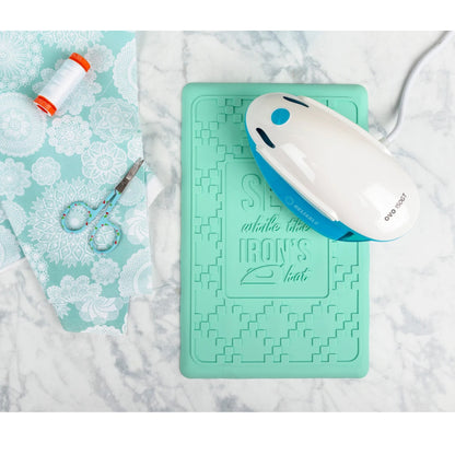 Turquoise ironing mat with a white and blue iron on a marble surface.