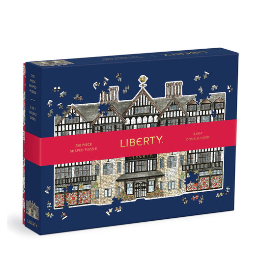 A boxed jigsaw puzzle on a white background. The box is dark blue with an illustrated timber-frame building and scattered puzzle-piece graphics.