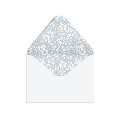 A white envelope with a light blue and white floral patterned liner, shown against a plain white background.
