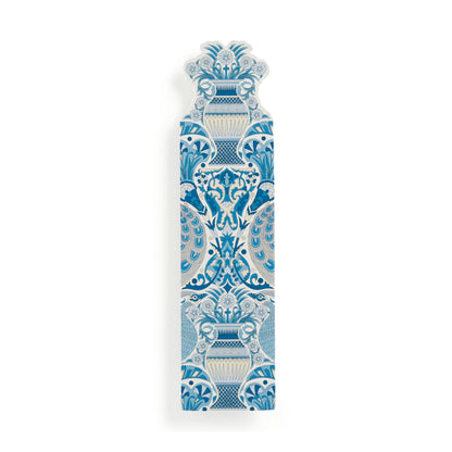 A decorative ceramic wall plaque featuring a symmetrical blue and white floral and scrollwork pattern, shown on a clean white background.
