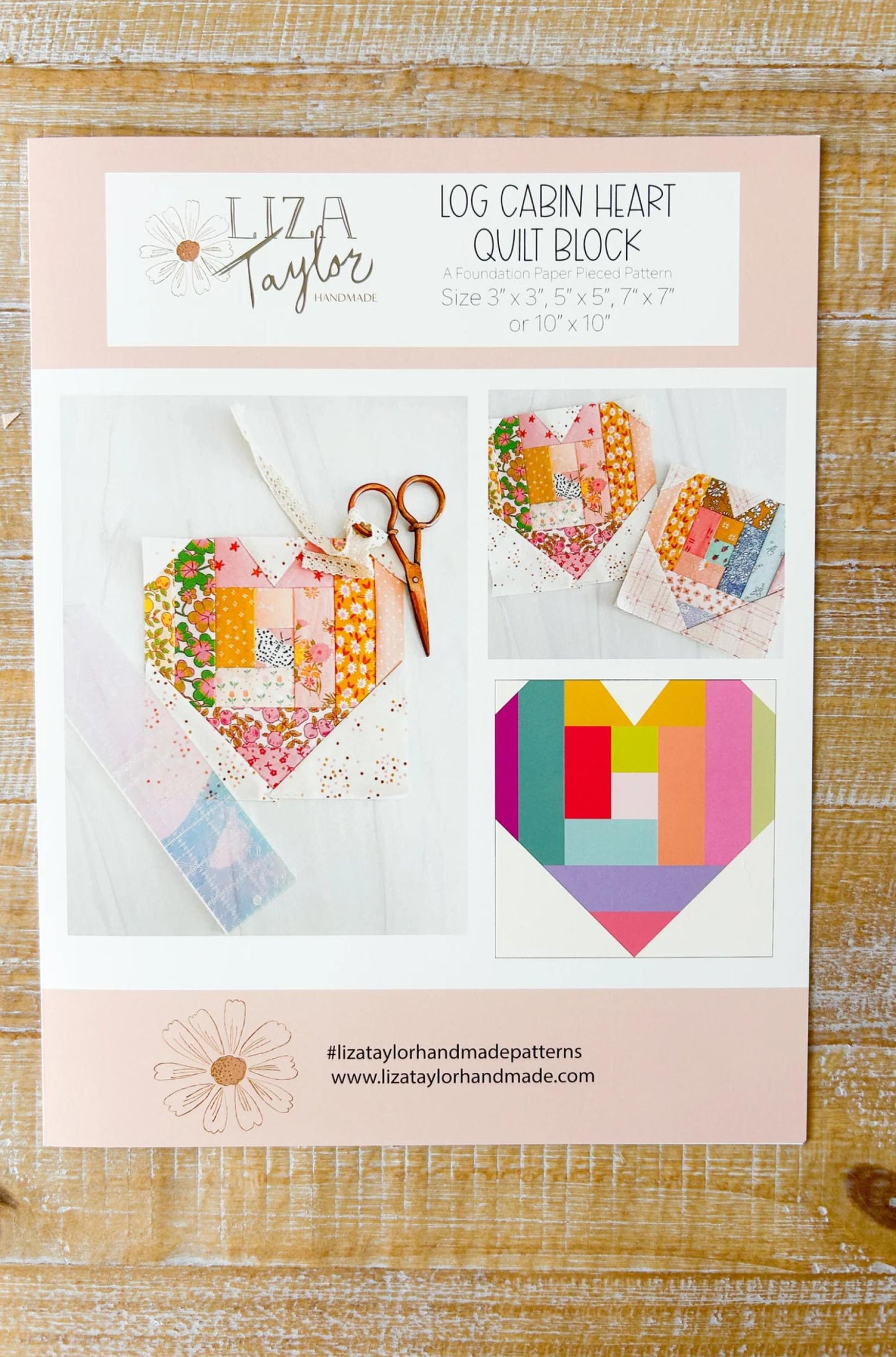 Liza Taylor Log Cabin Heart Quilt Block pattern on a wooden surface