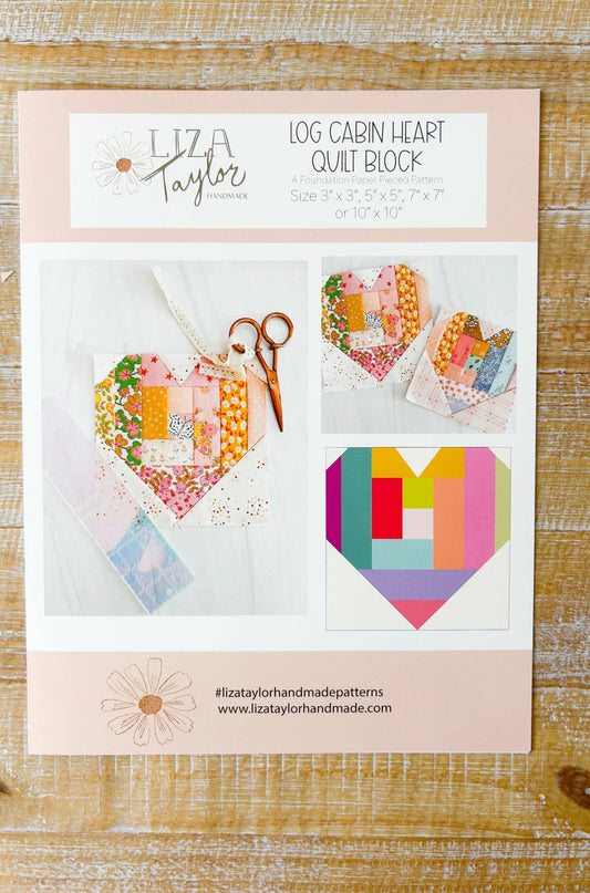 Liza Taylor Log Cabin Heart Quilt Block pattern on a wooden surface