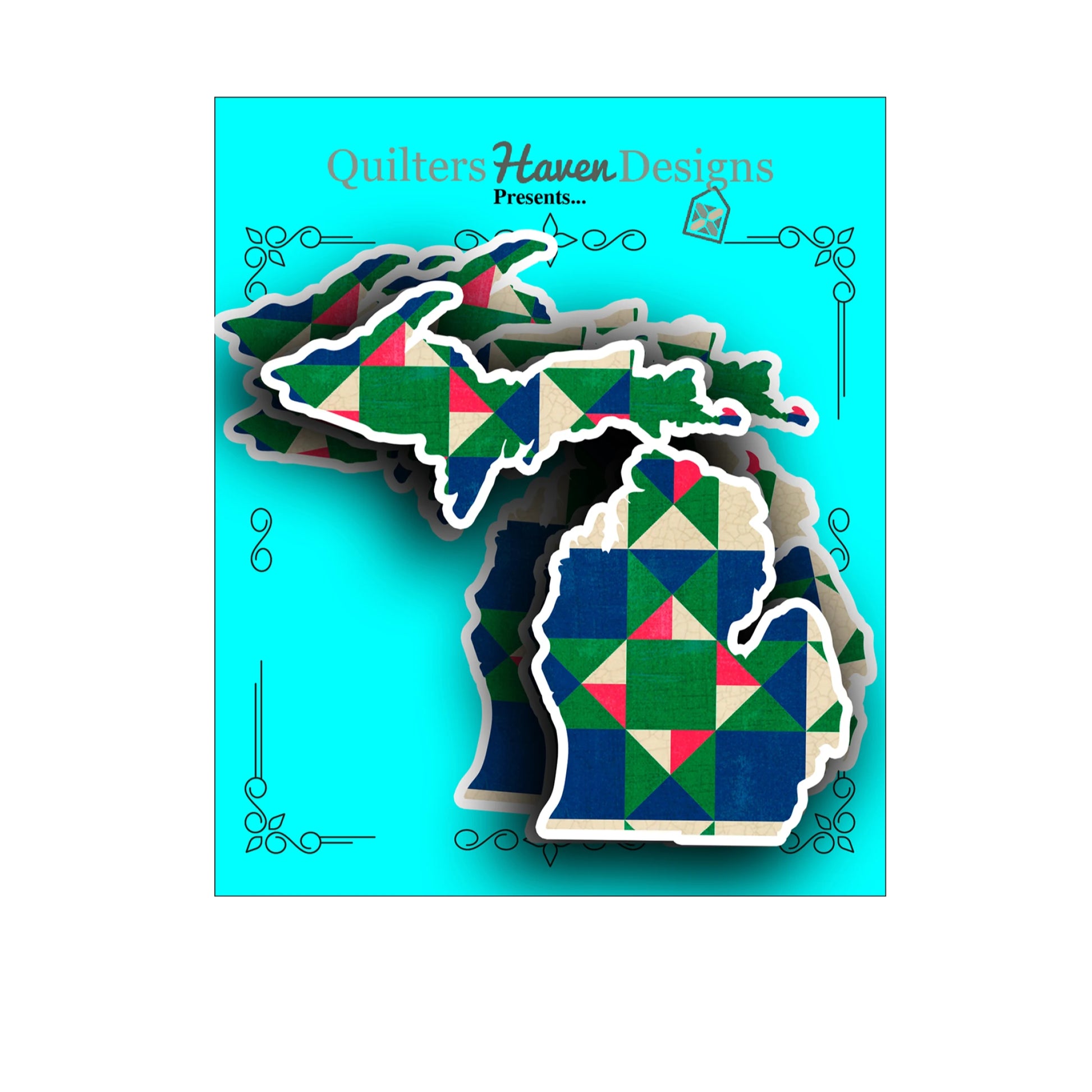 Stickers shaped like the state of Michigan, featuring a colorful geometric quilted pattern in green, blue, red, and cream. The cutouts are stacked on a turquoise card with 'Quilters Haven Designs Presents.