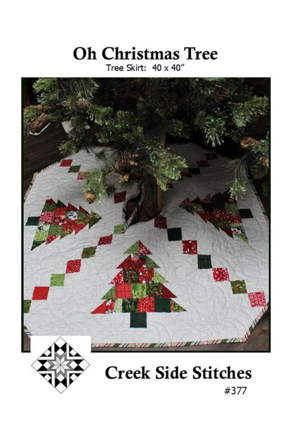 Christmas tree skirt with quilted design under a Christmas tree, featuring the brand 'Creek Side Stitches'.