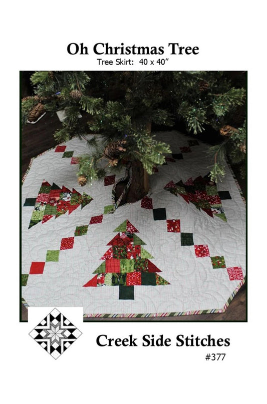 Christmas tree skirt with quilted design under a Christmas tree, featuring the brand 'Creek Side Stitches'.