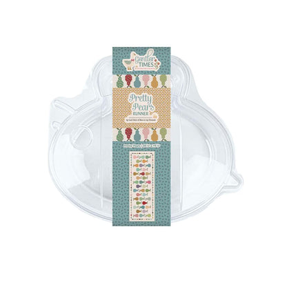 A clear plastic bee shaped quilt kit container with a decorative paper label. The label features the product name 'Pretty Pear's Runner' with colorful illustrations of pears and a patterned teal and beige design.