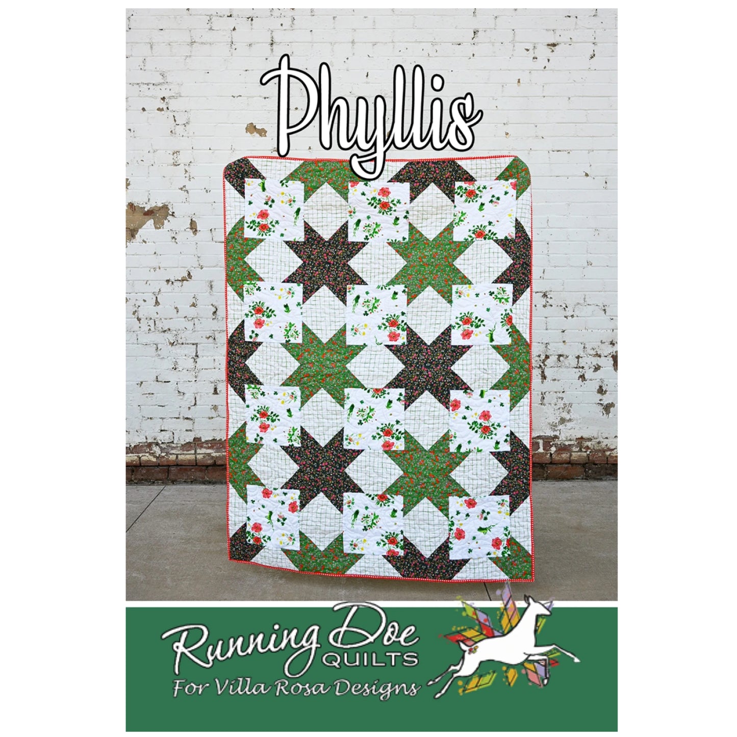 Quilt with star pattern on a white brick wall background, featuring 'Phyllis' and 'Running Doe Quilts' branding.