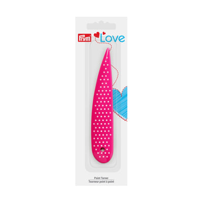 A pink point turner with white polka dots, packaged in a white cardboard sleeve with the brand name 'Pliim' and 'Love' printed on it.