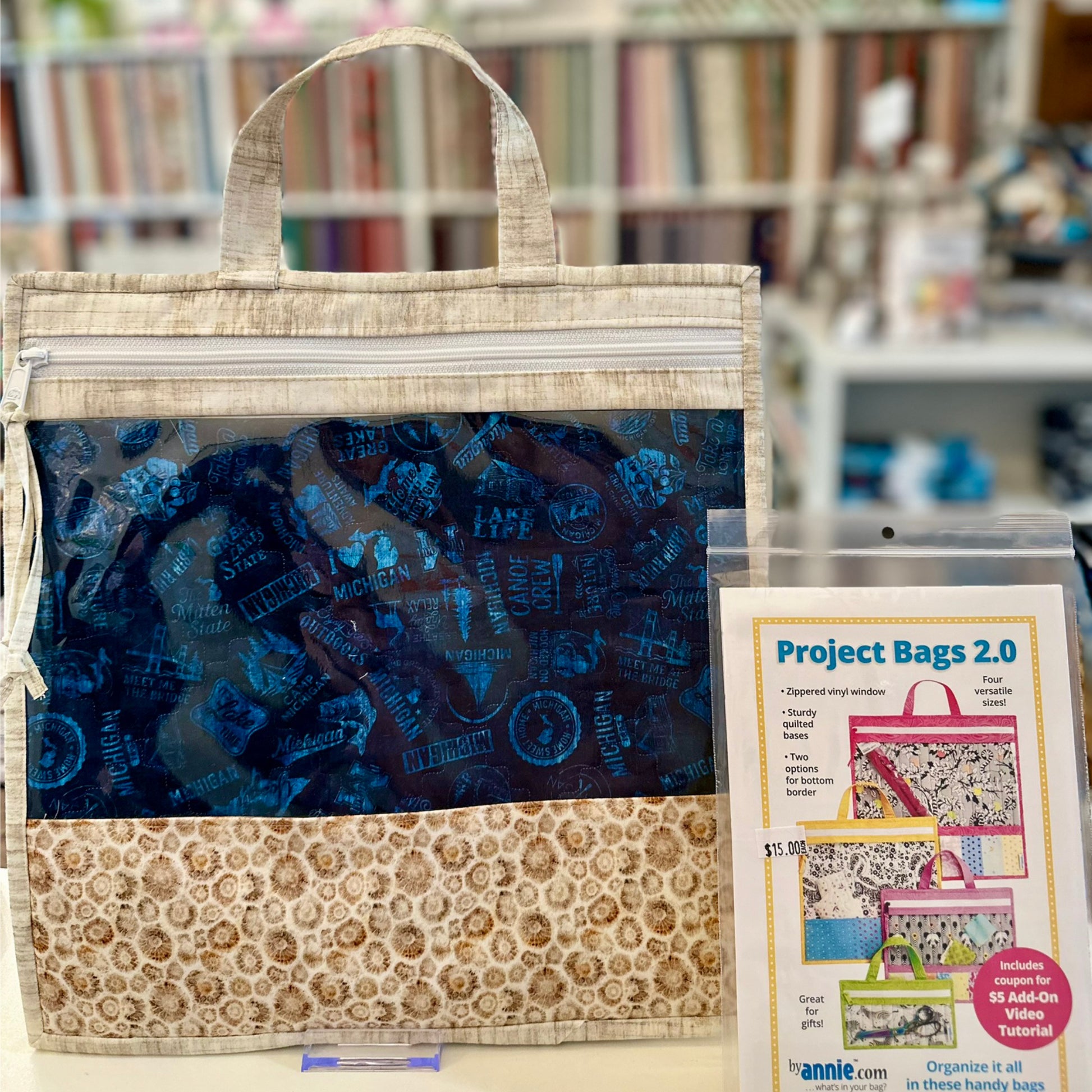 Fabric project bag with blue interior and floral exterior, displayed with a product card.