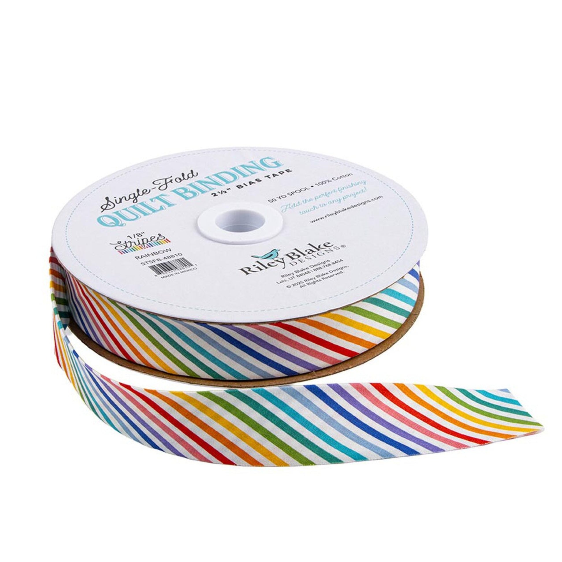A spool of Riley Blake Single First Quilt Binding grosgrain ribbon with a vibrant rainbow stripe pattern on a white background.