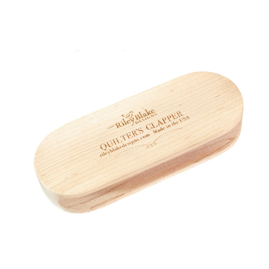 Wooden clapper with 'Riley Blake Designs' branding on a white background