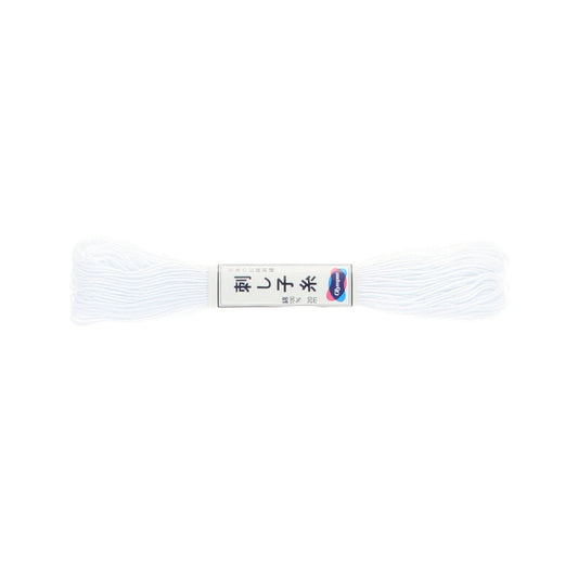 White thread spool with a label on a white background