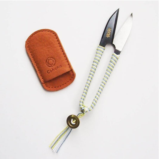 Silk Braid Snips with a leather sheath and decorative cord on a white background
