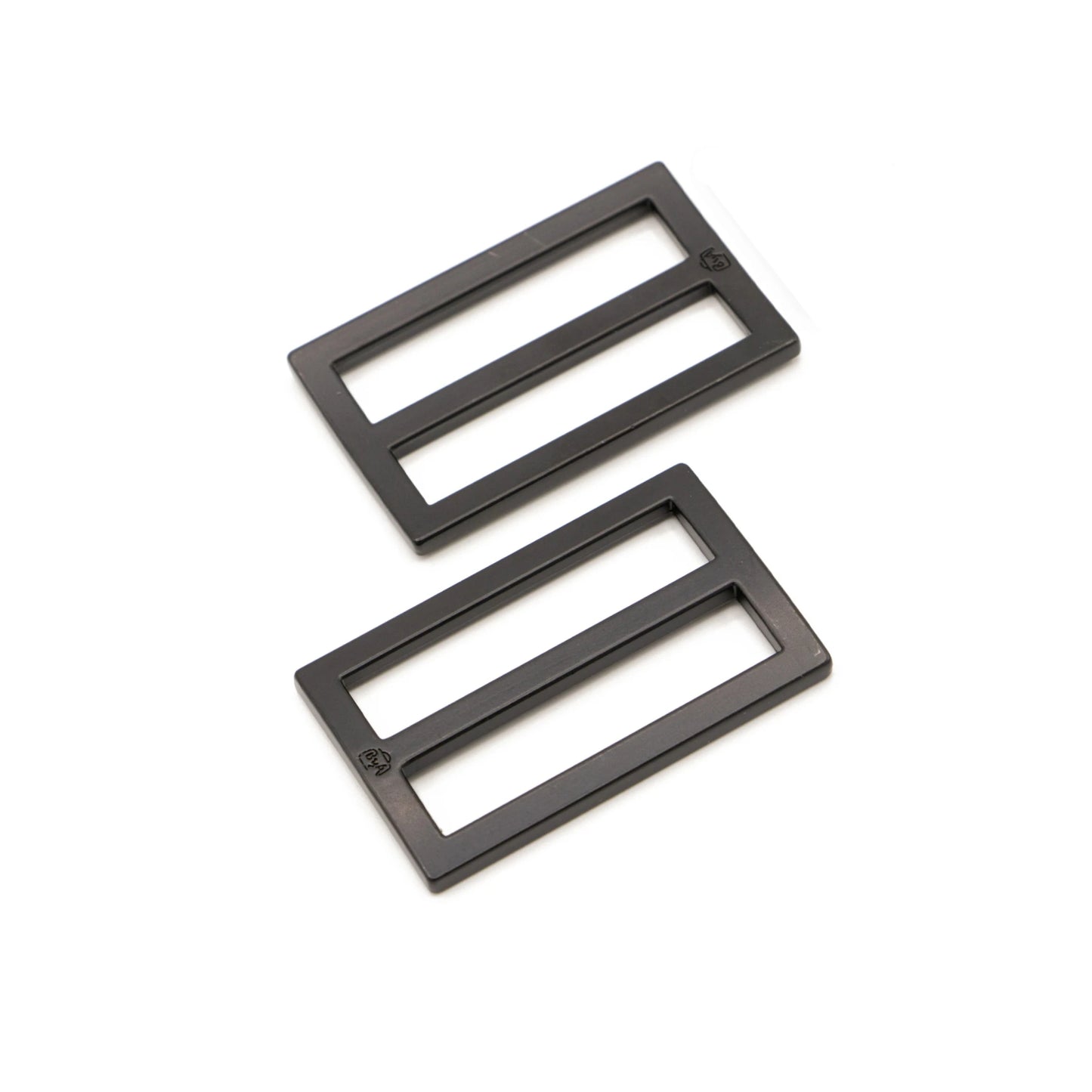 Two black rectangular metal sliders on a white background