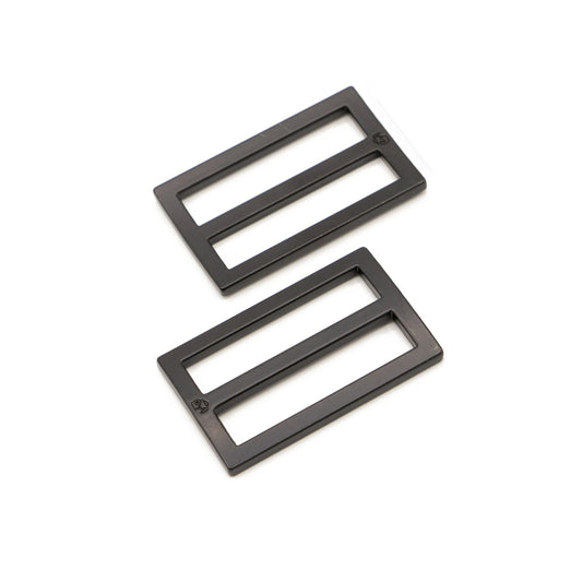 Two black rectangular metal sliders on a white background