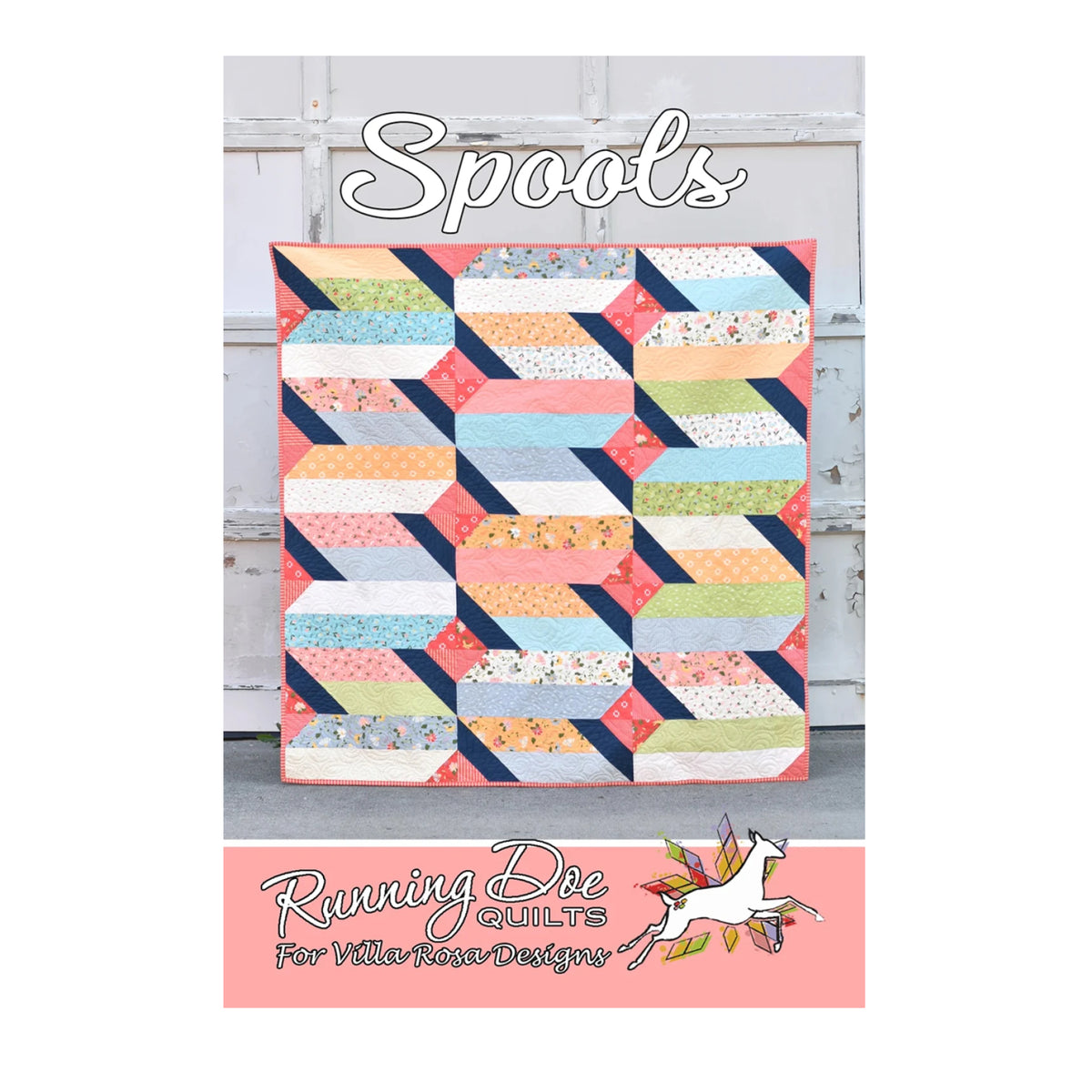 A colorful quilted patchwork design labeled 'Spools' is displayed against a weathered white wooden door. The quilt features geometric striped and diamond-like blocks in coral, navy, pink, yellow, green, and white.