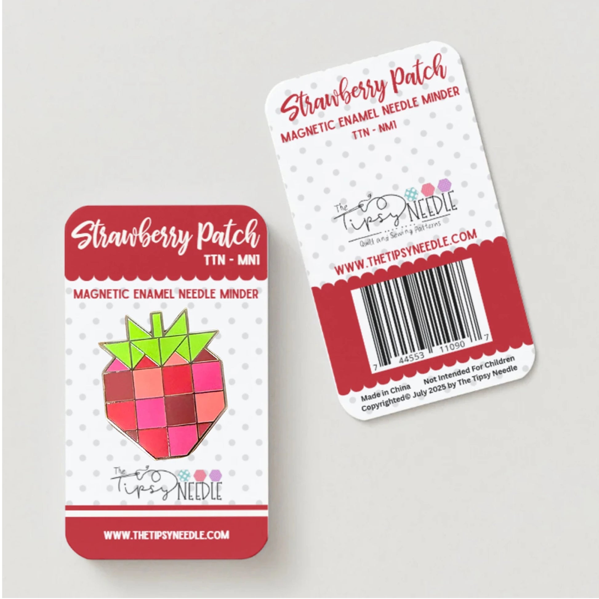 Two Strawberry Patch magnetic needle minders on a light gray background