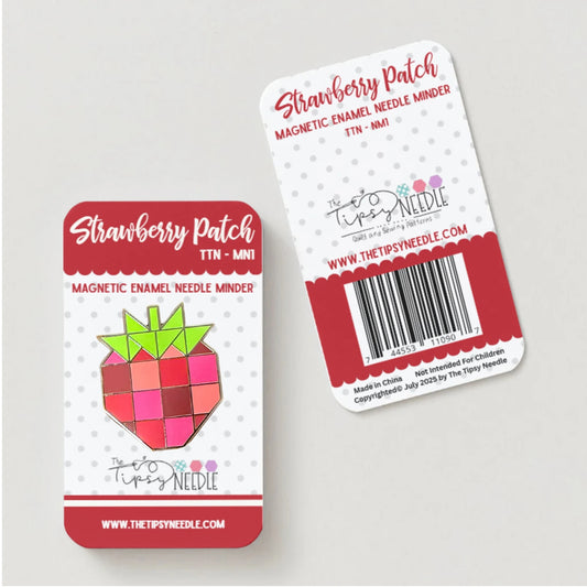 Two Strawberry Patch magnetic needle minders on a light gray background