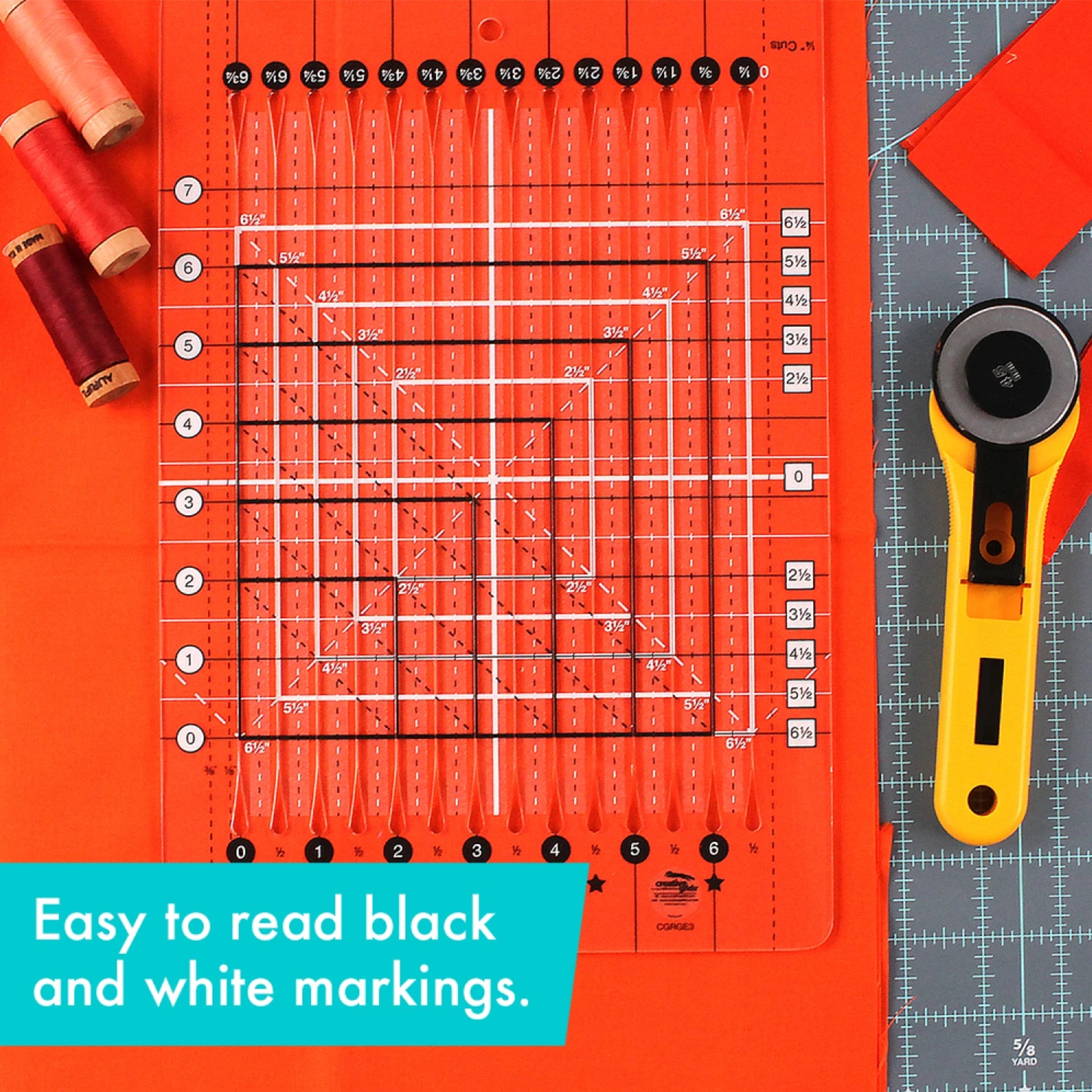 Quilting ruler with black and white markings on an orange background, accompanied by a rotary cutter.