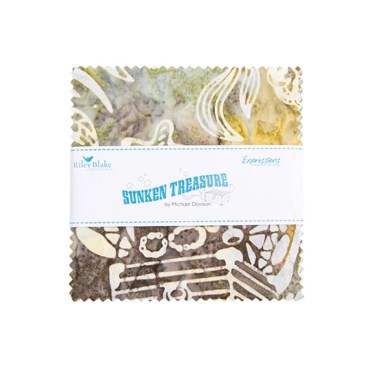 A folded fabric bundle with scalloped edges, wrapped in a white paper band labeled 'Sunkin Treasure' by Michael Donovan and Riley Blake Fabrics. The fabric features a collage-like pattern with abstract textures in beige, brown, gray, and muted green tones.
