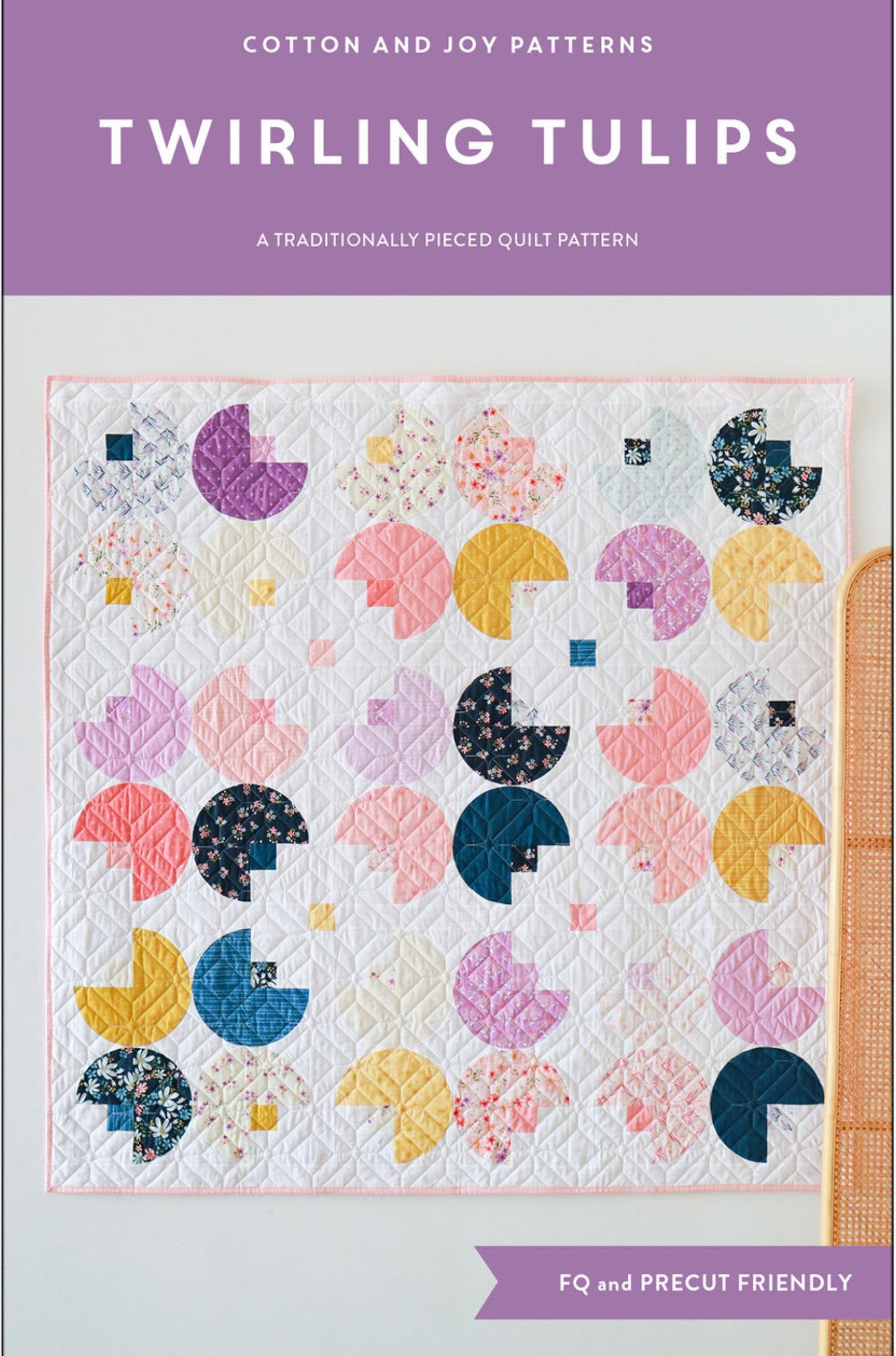 Pattern cover for 'Twirling Tulips' quilt pattern by Cotton and Joy Patterns, featuring a colorful quilt design with circular floral patches on a white background, with a purple header and footer.